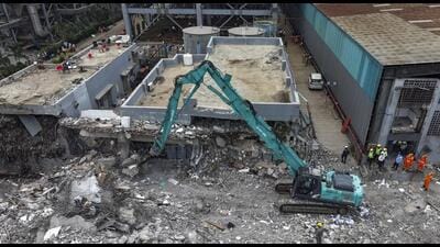 Moshi: An earth-mover removes debris at the site after a three-storey administrative building of a Waste-to-Energy (WTE) plant run by the Pimpri Chinchwad Municipal Corporation collapsed when an adjacent mound of garbage fell onto the structure like a landslide, in Pune district, Maharashtra, Saturday, July 11, 2026. The death toll has risen to eight while 14 of the estimated 23 persons stuck inside have been rescued in this incident, a senior official said. (PTI Photo)(PTI07_11_2026_000601B) (PTI) Moshi: An earth-mover removes debris at the site after a three-storey administrative building of a Waste-to-Energy (WTE) plant run by the Pimpri Chinchwad Municipal Corporation collapsed when an adjacent mound of garbage fell onto the structure like a landslide, in Pune district, Maharashtra, Saturday, July 11, 2026. The death toll has risen to eight while 14 of the estimated 23 persons stuck inside have been rescued in this incident, a senior official said. (PTI Photo)(PTI07_11_2026_000601B) (PTI)