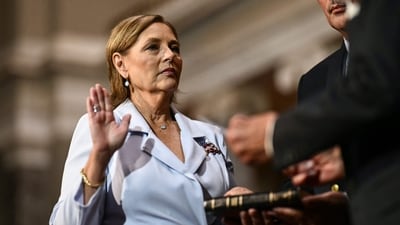 Darline Graham Nordone, sister of Lindsey Graham, is ceremonially sworn in as a US Senator by Senator Charles Grassley, Republican from Iowa, (out of frame) in the Old Senate Chamber at the US Capitol in Washington, DC. (AFP)