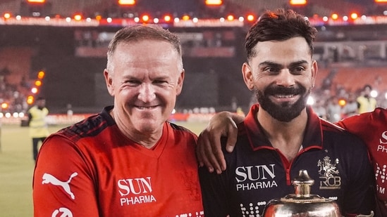 Royal Challengers Bengaluru's Head Coach Andy Flower and Virat Kohli hold the trophy after winning the Indian Premier League (IPL) 2026 title