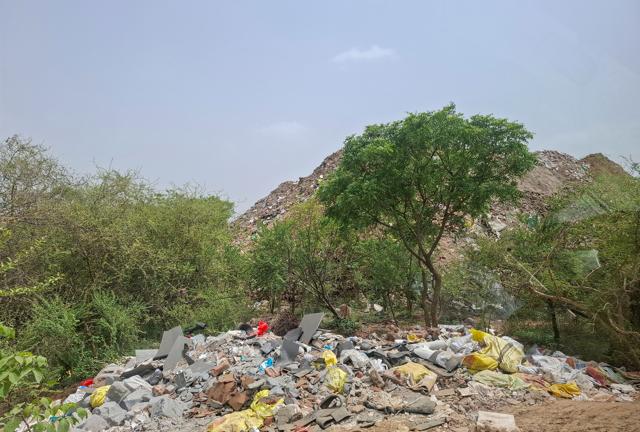 Illegally dumped construction and demolition waste seen behind the biodiversity park near DLF Ph-3 seen on Monday. (Parveen Kumar/HT) Illegally dumped construction and demolition waste seen behind the biodiversity park near DLF Ph-3 seen on Monday. (Parveen Kumar/HT)