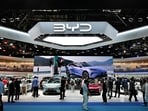 People visit the BYD booth at the Beijing Auto Show.