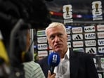 France's head coach Didier Deschamps speaks with a sports broadcaster after his team lost the 2026 World Cup football tournament semi-final match between France and Spain at the Dallas Stadium