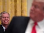 File photo of Lindsey Graham listening as President Donald Trump speaks.