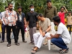 Climate activist Sonam Wangchuk being attended as Cockroach Janata Party (CJP) founder Abhijeet Dipke looks on during a protest by CJP demanding Union Education Minister Dharmendra Pradhan's resignation over alleged irregularities in the NEET examination, at Jantar Mantar, in New Delhi.