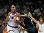 Phoenix Mercury forward Alyssa Thomas, left, tries to go up for a shot against Chicago Sky forward Aicha Coulibaly during the first half of a WNBA basketball game, July 7, 2026, in Phoenix.
