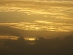Smoke from Canadian wildfires turns the Boston skyline hazy yellow-orange as air quality alerts remain in effect.