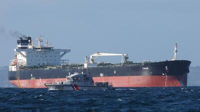 A French Navy vessel sails by the Russian oil tanker “Tagor”, suspected of flying a false Cameroonian flag and boarded by the French Navy on May 31 as it arrives in Douarnenez Bay, western France on June 2. (AFP) A French Navy vessel sails by the Russian oil tanker “Tagor”, suspected of flying a false Cameroonian flag and boarded by the French Navy on May 31 as it arrives in Douarnenez Bay, western France on June 2. (AFP)