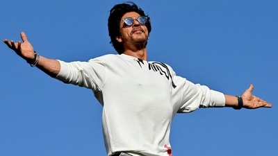Bollywood actor Shah Rukh Khan greets fans with his iconic pose at his residence Mannat in Mumbai on June 10, 2023. (AFP)