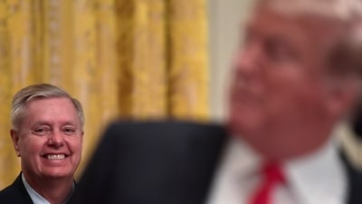 File photo of Lindsey Graham listening as President Donald Trump speaks. (AP Photo)