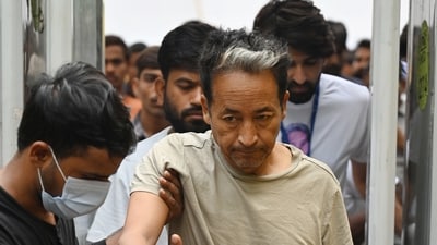 Activist Sonam Wangchuk is assisted by volunteers during his daily morning routine as he continues his indefinite hunger strike for the 18th consecutive day at Jantar Mantar in New Delhi on Wednesday, July 15, 2026. The protest, held in solidarity with the Cockroach Janta Party (CJP), demands resignation of Union education minister Dharmendra Pradhan over exam-related irregularities and paper leaks. (Vipin Kumar/HT Photo) Activist Sonam Wangchuk is assisted by volunteers during his daily morning routine as he continues his indefinite hunger strike for the 18th consecutive day at Jantar Mantar in New Delhi on Wednesday, July 15, 2026. The protest, held in solidarity with the Cockroach Janta Party (CJP), demands resignation of Union education minister Dharmendra Pradhan over exam-related irregularities and paper leaks. (Vipin Kumar/HT Photo)