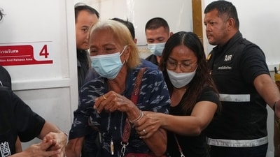 A relative of a victim in a music bar fire cries while receiving the victim's body at a police hospital in Bangkok, Thailand, Wednesday, July 15, 2026. (AP )