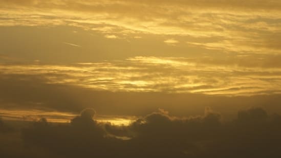 Smoke from Canadian wildfires turns the Boston skyline hazy yellow-orange as air quality alerts remain in effect.