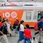 Kolkata: Passengers arrive to board an EMU local train decorated to commemmorate 100 years of electrification by the Indian Railways, at Howrah Station in Kolkata, Tuesday, Feb. 4, 2025. (PTI Photo)(PTI02_04_2025_000392B)