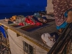Residents sleep on the roof of their home near Versova Beach to escape the oppressive indoor heat amid hot and humid conditions in Mumbai