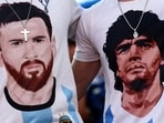 Argentina fans wearing t-shirts depicting Lionel Messi and Diego Maradona. (REUTERS)