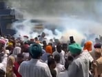 Police use tear gas on MGNREGA employees demanding pending wages outside the residence of Punjab rural development minister Tarunpreet Singh Sond in Khanna on Wednesday. (HT Photo)