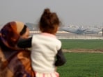 People look at a US military plane deporting Indian immigrants as it lands in Amritsar. 