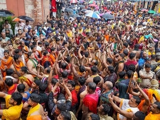Devotees play traditional Odia gong (Ghanta) during the Mahaprabhu Jagannath Rath Yatra at Puri Jagannath temple, in Puri on Thursday.&nbsp;