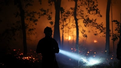 More than 100 wildfires are burning in Canada, where a train crew in northern Ontario filmed themselves surrounded by flames before being safely evacuated. (REUTERS)