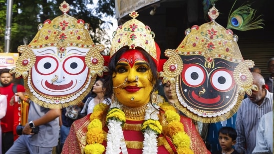 &nbsp;A devotee dresses up to signify to Lord Jagannath, His brother Balabhadra, and His sister Subhadra during the 149th Lord Jagannath Rath Yatra, in Ahmedabad on Thursday. The procession starts from Jagannath Temple in Ahmedabad's Jamalpur. (ANI Photo)