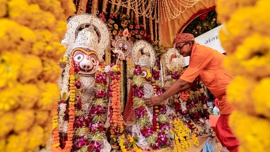 A priest attends to the idols of Lord Jagannath, Lord Balabhadra and Goddess Subhadra on the chariot during the annual Jagannath Rath Yatra procession in Prayagraj, Uttar Pradesh, Thursday, July 16.&nbsp;(PTI)