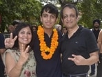 Aryan Gupta celebrating with his parents Dr Reenu Gupta, a gynaecologist, and Dr Sachin Gupta, an anaesthesiologist, in Ludhiana on Friday. (Gurpreet Singh/HT)