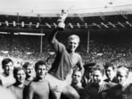 England's national soccer team captain Bobby Moore holds aloft the Jules Rimet trophy as he is carried by his teammates following England's victory over Germany in the World Cup final on July 30, 1966 at Wembley stadium in London.