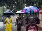 People use umbrellas during rainfall. The IMD has forecast widespread showers across the capital from July 20.