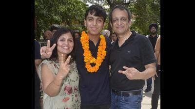 Aryan Gupta celebrating with his parents Dr Reenu Gupta, a gynaecologist, and Dr Sachin Gupta, an anaesthesiologist, in Ludhiana on Friday. (Gurpreet Singh/HT) Aryan Gupta celebrating with his parents Dr Reenu Gupta, a gynaecologist, and Dr Sachin Gupta, an anaesthesiologist, in Ludhiana on Friday. (Gurpreet Singh/HT)