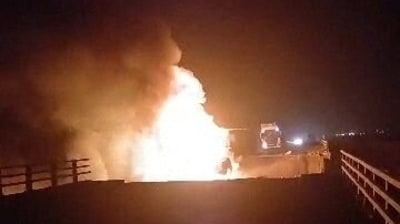 A fire burns on a damaged bridge in the aftermath of a strike, in Bandar Khamir, Hormozgan province, Iran July 16, 2026 (REUTERS)