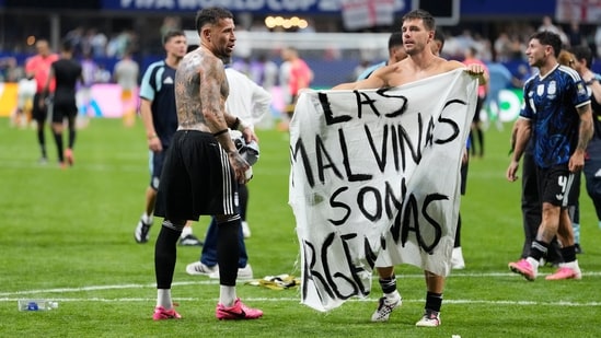 Argentina's Giovani Lo Celso holds the banner.