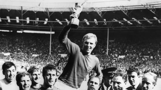 England's national soccer team captain Bobby Moore holds aloft the Jules Rimet trophy as he is carried by his teammates following England's victory over Germany in the World Cup final on July 30, 1966 at Wembley stadium in London.