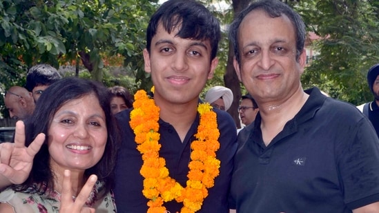 NEET PG 2026 topper Aryan Gupta with his parents in Ludhiana 