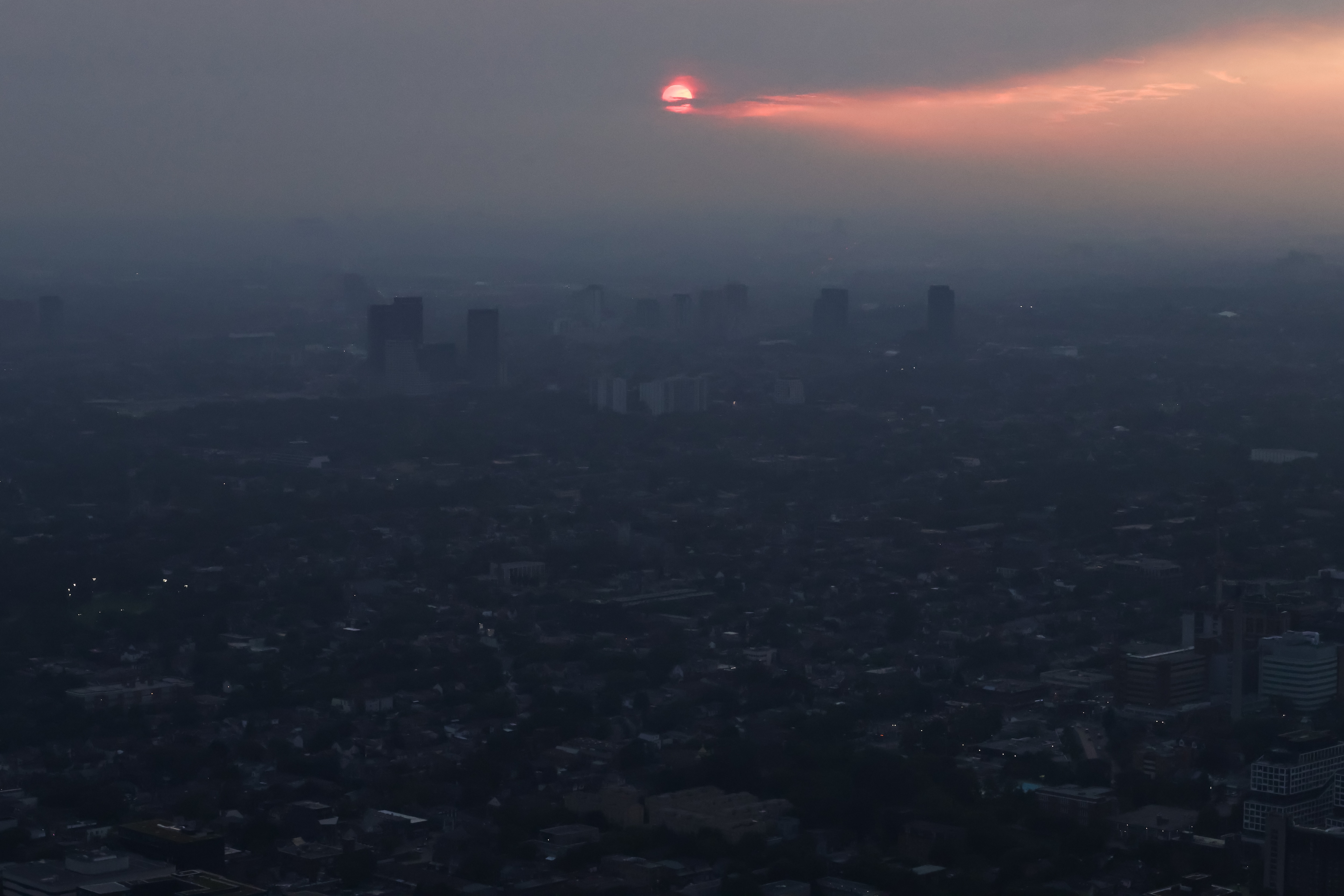 Buildings are seen from the observation deck of the CN Tower as smoke from wildfires in northwestern Ontario blankets the city of Toronto. (The Canadian Press via AP ) Buildings are seen from the observation deck of the CN Tower as smoke from wildfires in northwestern Ontario blankets the city of Toronto. (The Canadian Press via AP )