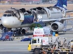 Inspectors examining an Air Busan plane last year after a power-bank fire in an overhead bin.
