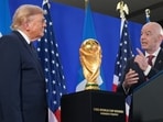 President Donald Trump listens as FIFA President Gianni Infantino speaks at a reception.