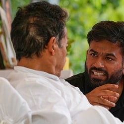 Abhijeet Dipke, founder of the Cockroach Janta Party, center, talks to climate activist Sonam Wangchuk.