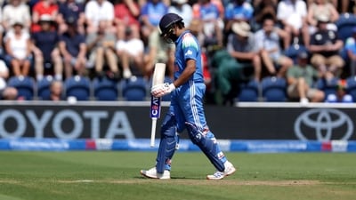 Rohit Sharma walks off the pitch after being caught out by England's Jos Buttler during the second ODI. (AP)