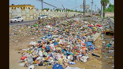 Piles of garbage dot the area; and a road riddled with potholes gets waterlogged after every spell of rain in Haibowal, Ludhiana. (HT PHOTO) Piles of garbage dot the area; and a road riddled with potholes gets waterlogged after every spell of rain in Haibowal, Ludhiana. (HT PHOTO)
