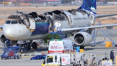 Inspectors examining an Air Busan plane last year after a power-bank fire in an overhead bin. (Shutterstock) Inspectors examining an Air Busan plane last year after a power-bank fire in an overhead bin. (Shutterstock)