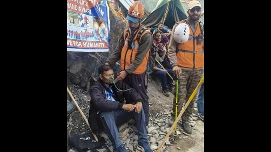 A member of Jammu and Kashmir Police’s Mountain Rescue Team administers oxygen to a pilgrim during the Amarnath Yatra on the Pahalgam route in Anantnag district on Friday. (PTI Photo)