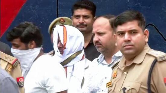 A police team takes two accused, Ram Shankar Yadav (alias Tinnu Yadav) and Manish Yadav from the district jail for 39-hour police remand in connection with the Ram temple alleged donations embezzlement case, in Ayodhya on Saturday. (ANI VIDEO GRAB)