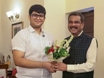 Union education minister Dharmendra Pradhan with Panshul Bansal from Haryana, who secured AIR 2 in NEET-UG 2026, in New Delhi on Sunday.