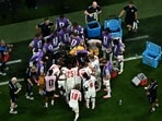 England's players huddle during a hydration break.