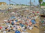 Piles of garbage dot the area; and a road riddled with potholes gets waterlogged after every spell of rain in Haibowal, Ludhiana. (HT PHOTO)