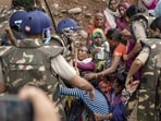 Security personnel remove protesters from the banks of the Barana river, bringing a 15-day agitation against the Ken-Betwa Link and other development projects to an end, in Chhatarpur, Madhya Pradesh, on Sunday. (PTI)