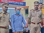 The accused, Girish Mishra, in police custody. (Sourced)