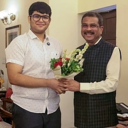 Union education minister Dharmendra Pradhan with Panshul Bansal from Haryana, who secured AIR 2 in NEET-UG 2026, in New Delhi on Sunday.