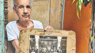 93-year-old man in Sita Ram Bazaar keeps photograph of a group portrait of a poetry club from 1911, called Bazm-e-Shaida. (Courtesy: Nancy Sardana) 93-year-old man in Sita Ram Bazaar keeps photograph of a group portrait of a poetry club from 1911, called Bazm-e-Shaida. (Courtesy: Nancy Sardana)