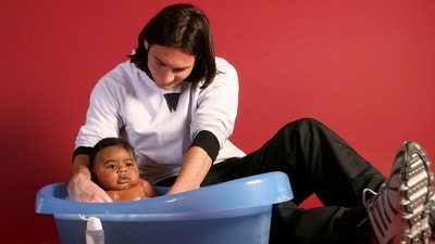 20-year-old soccer star Lionel Messi bathes baby Lamine Yamal. (AP) 20-year-old soccer star Lionel Messi bathes baby Lamine Yamal. (AP)